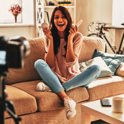 A female small business owner on camera telling a story while implementing her video marketing strategy for small businesses.