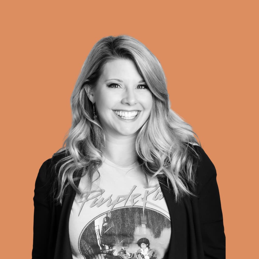 Image of team member Jori Stevian Delaney, in black and white with an pale orange background