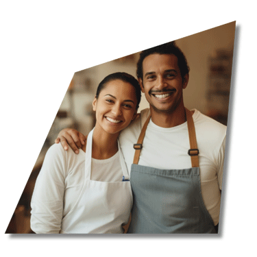 A couple smile as they grow their pizza business with marketing agency.