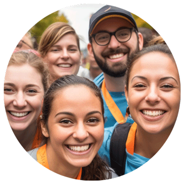Group of young nonprofit workers, both male and female, smiling at the camera.