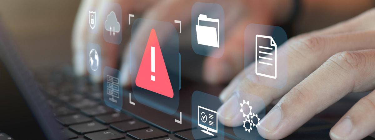 Hands typing with warning icons displayed