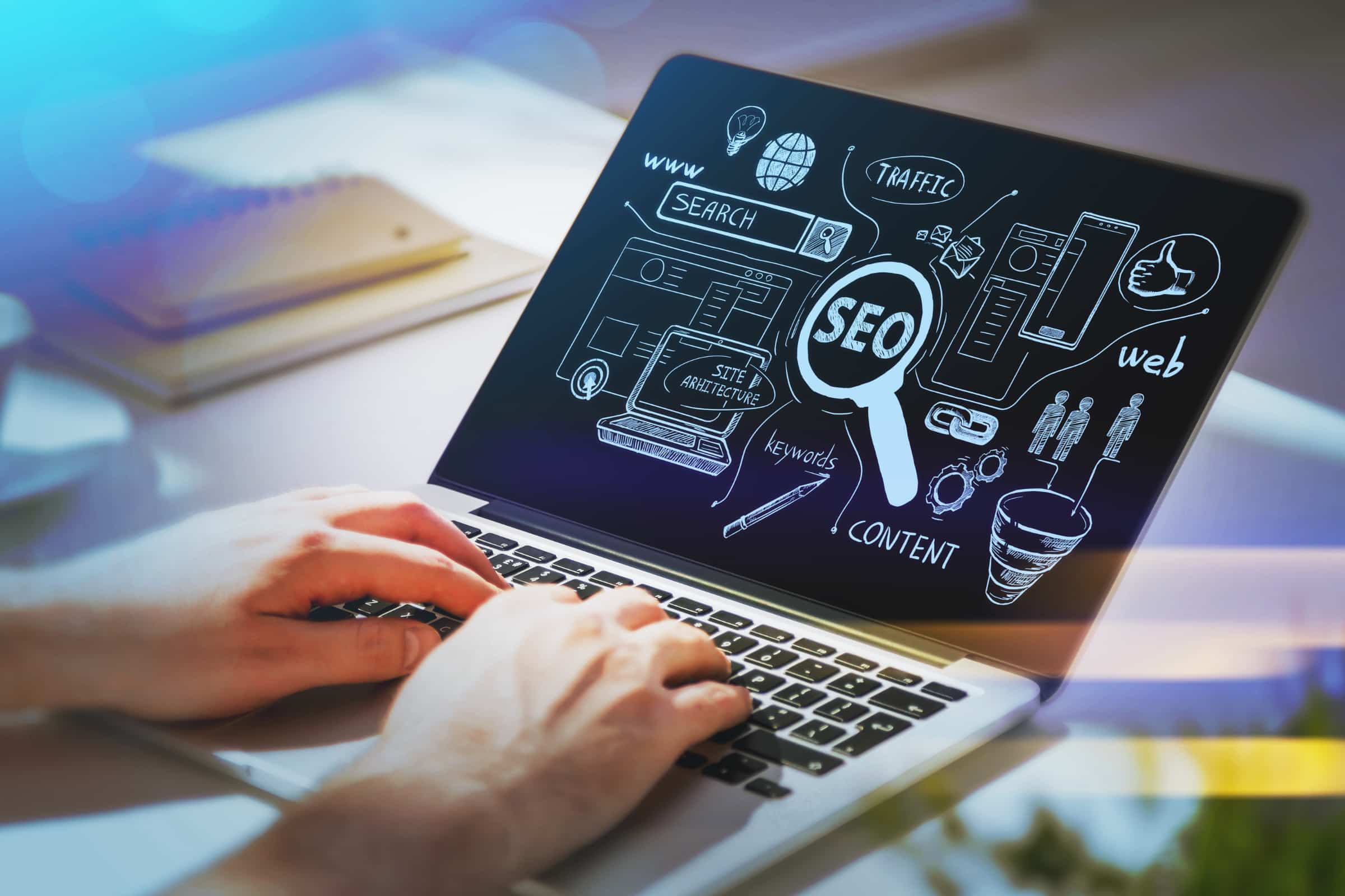 Hands typing on laptop showing multilingual SEO, keywords, content, and traffic.