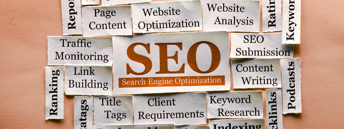 SEO team concept with words like link building, keyword research, and website optimization around SEO.