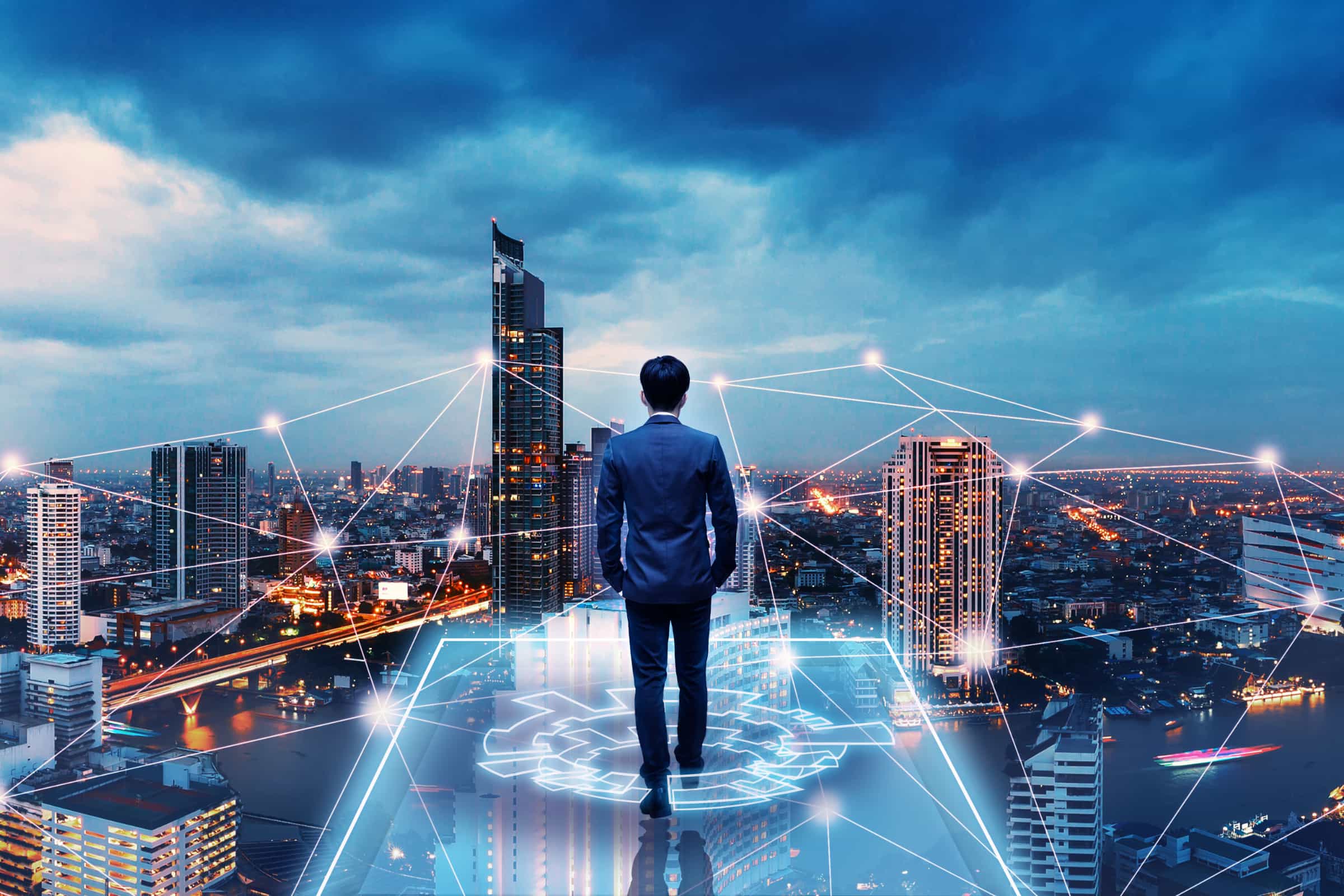 Importance of Business Listing in SEO shown as a businessman overlooking connected city network skyline
